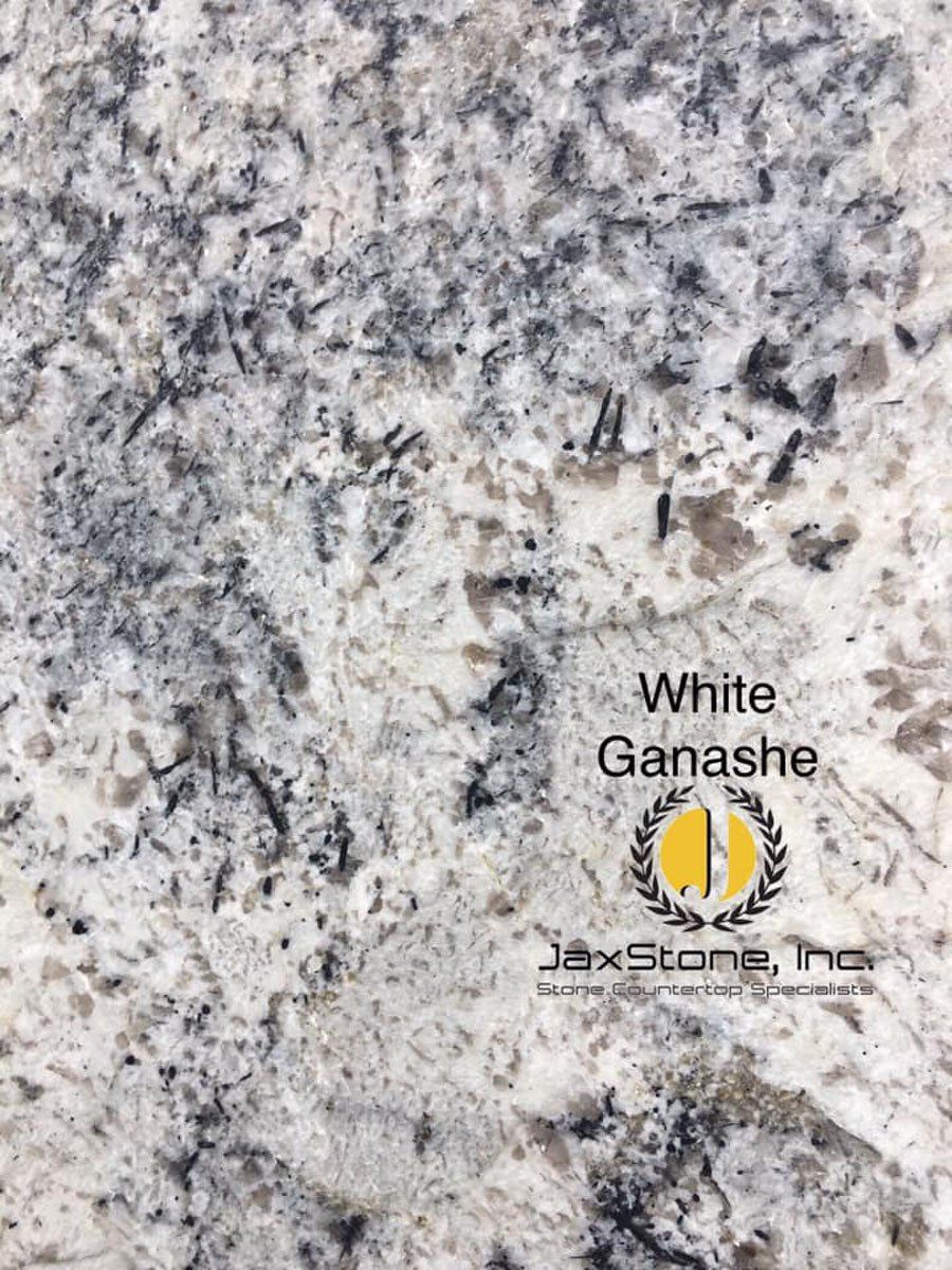 A close up of a white granite counter top.
