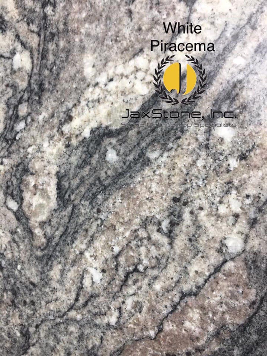 A close up of a white piracyma granite counter top.
