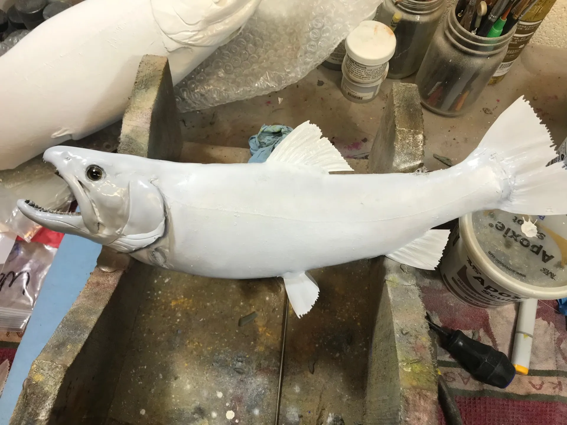 A white fish is sitting on top of a table.