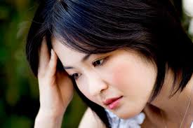 Asian woman leaning hand on head