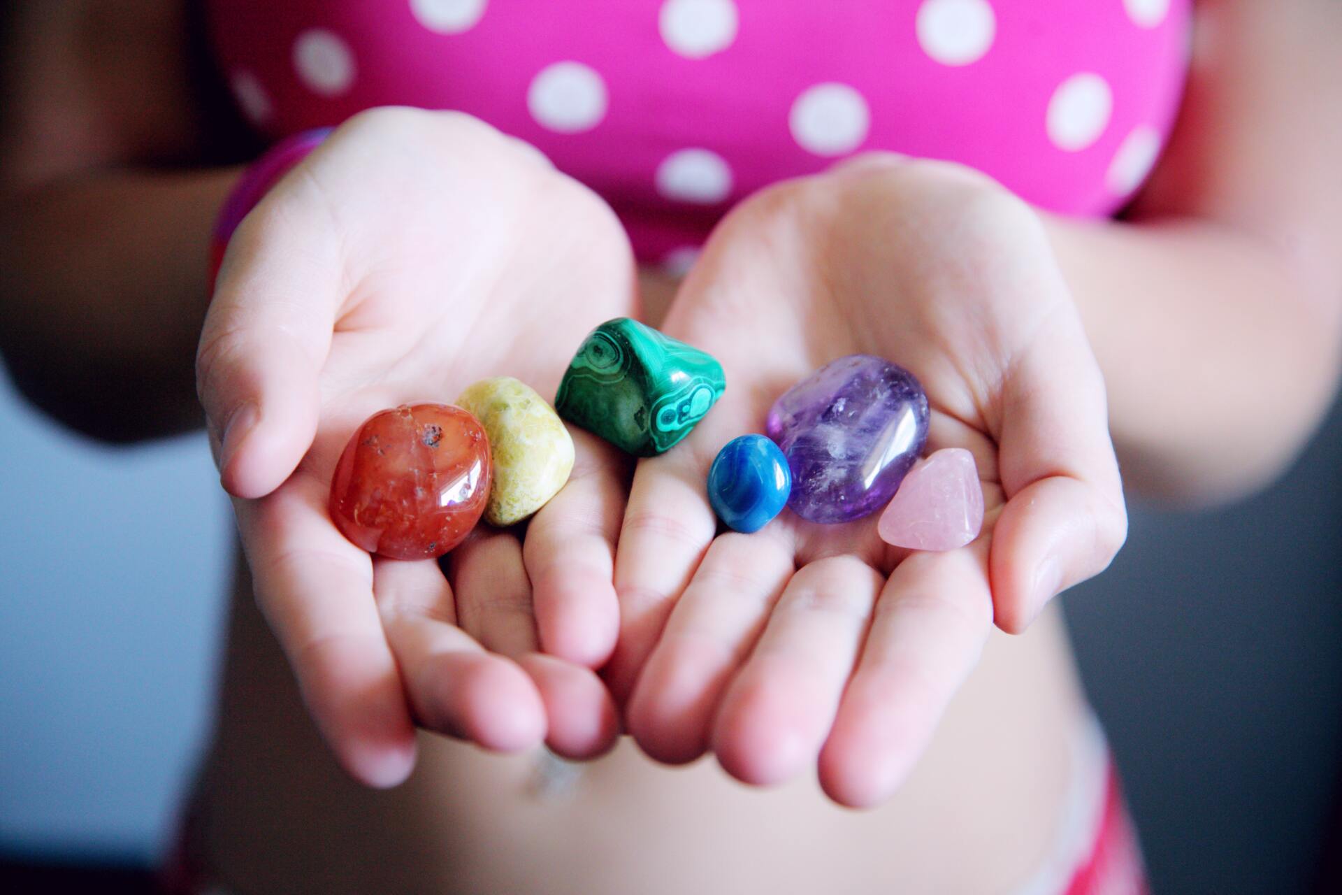 Mulit-colored stones in open hands