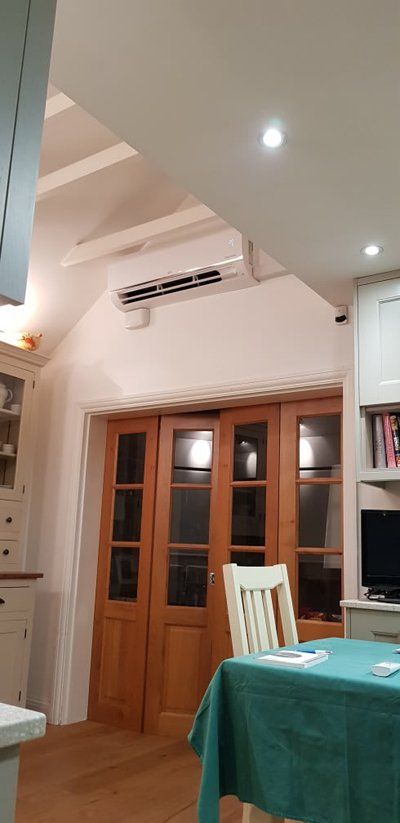 air conditioning by brown doors