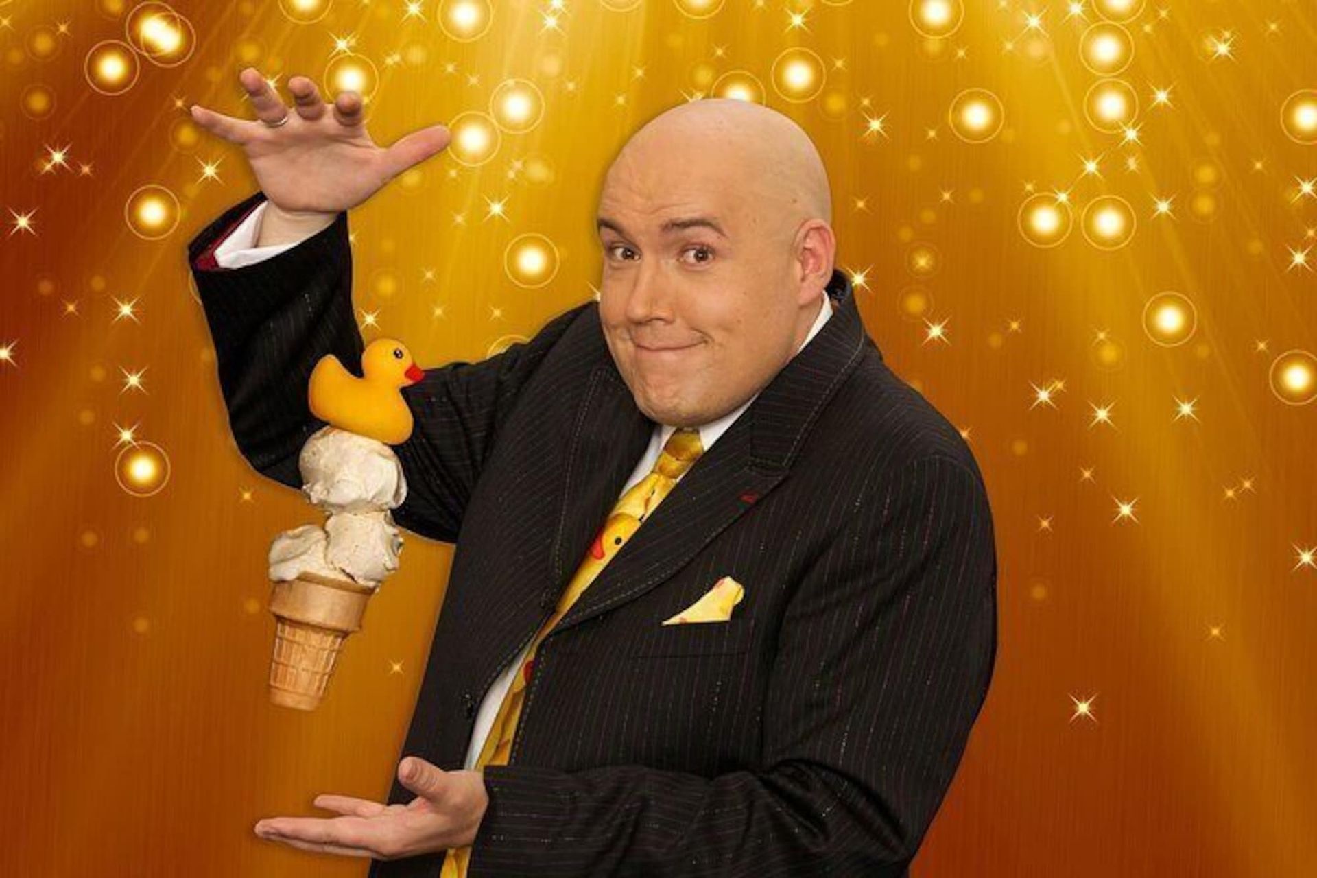 a bald man in a suit and tie is holding an ice cream cone and a stuffed duck .