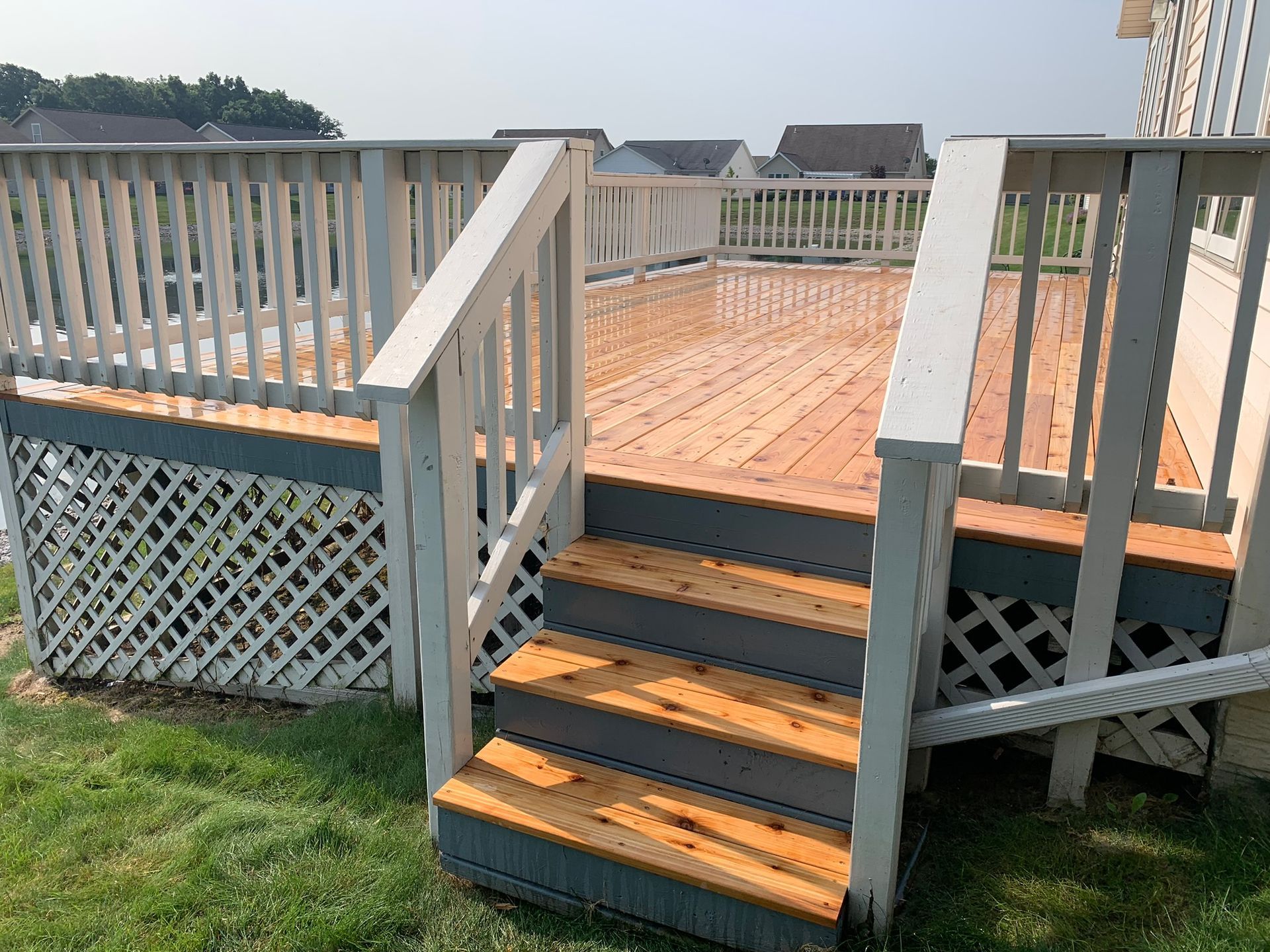 Outdoor deck steps with white railing by NorthPoint Remodeling, Northwest Ohio