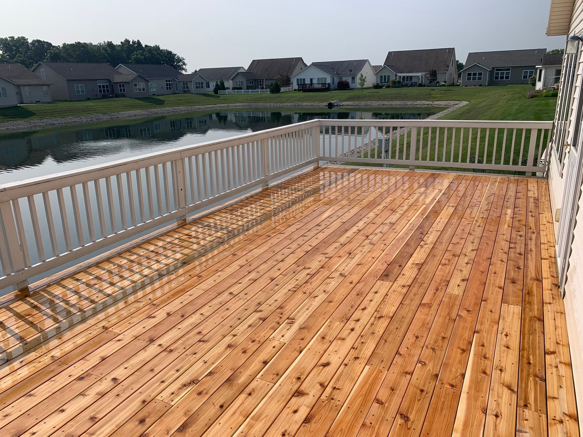 Outdoor deck with white railing by NorthPoint Remodeling, Northwest Ohio