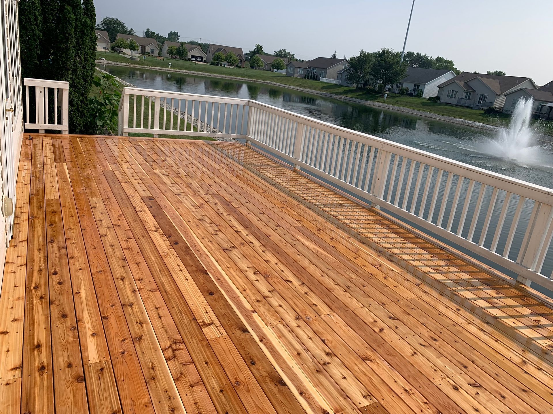 Outdoor deck with white railing by NorthPoint Remodeling, Northwest Ohio
