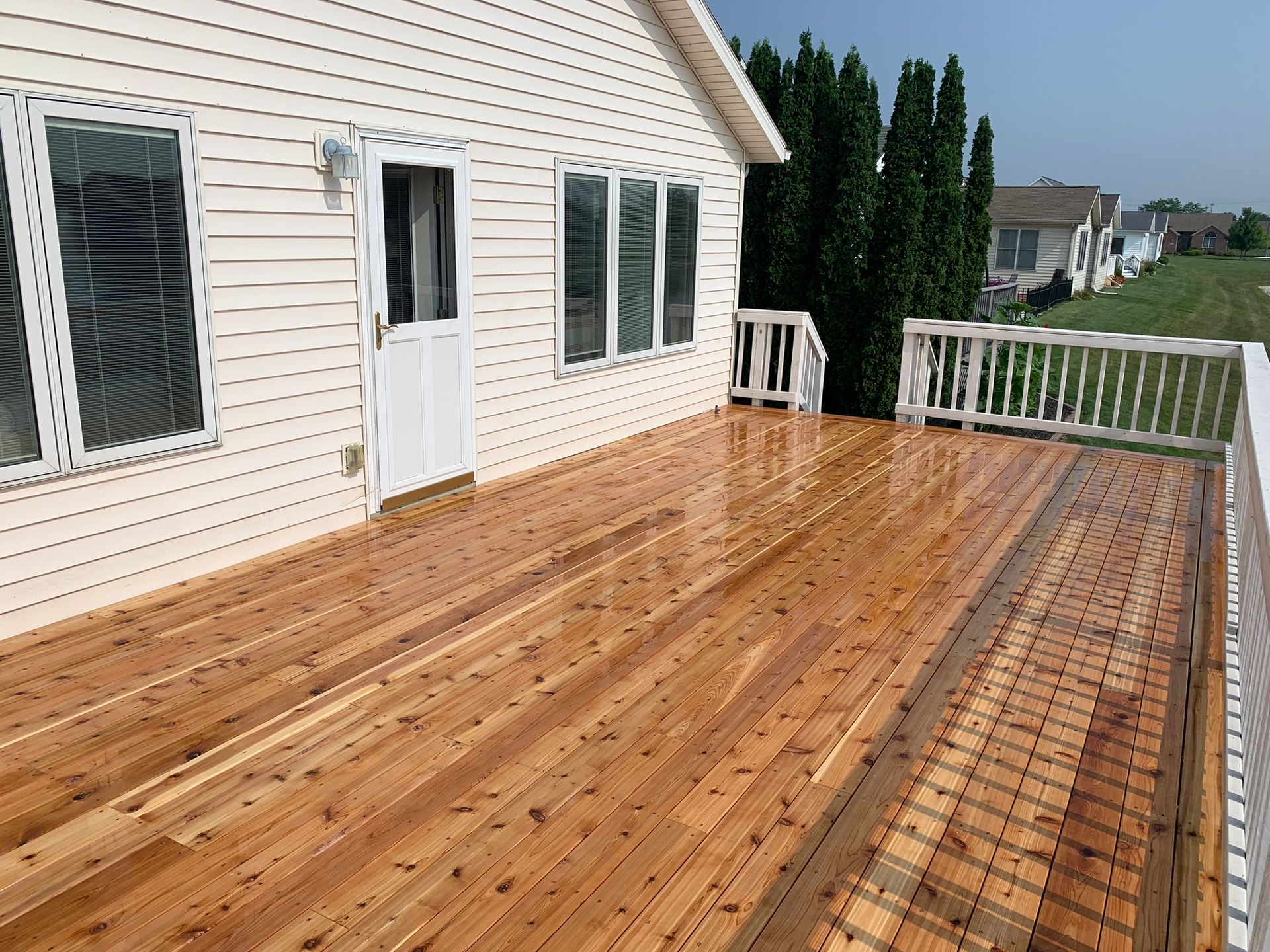 Outdoor deck with white railing by NorthPoint Remodeling, Northwest Ohio