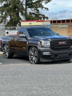 A black gmc truck is parked in a parking lot.