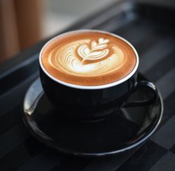 A cup of cappuccino on a saucer on a tray
