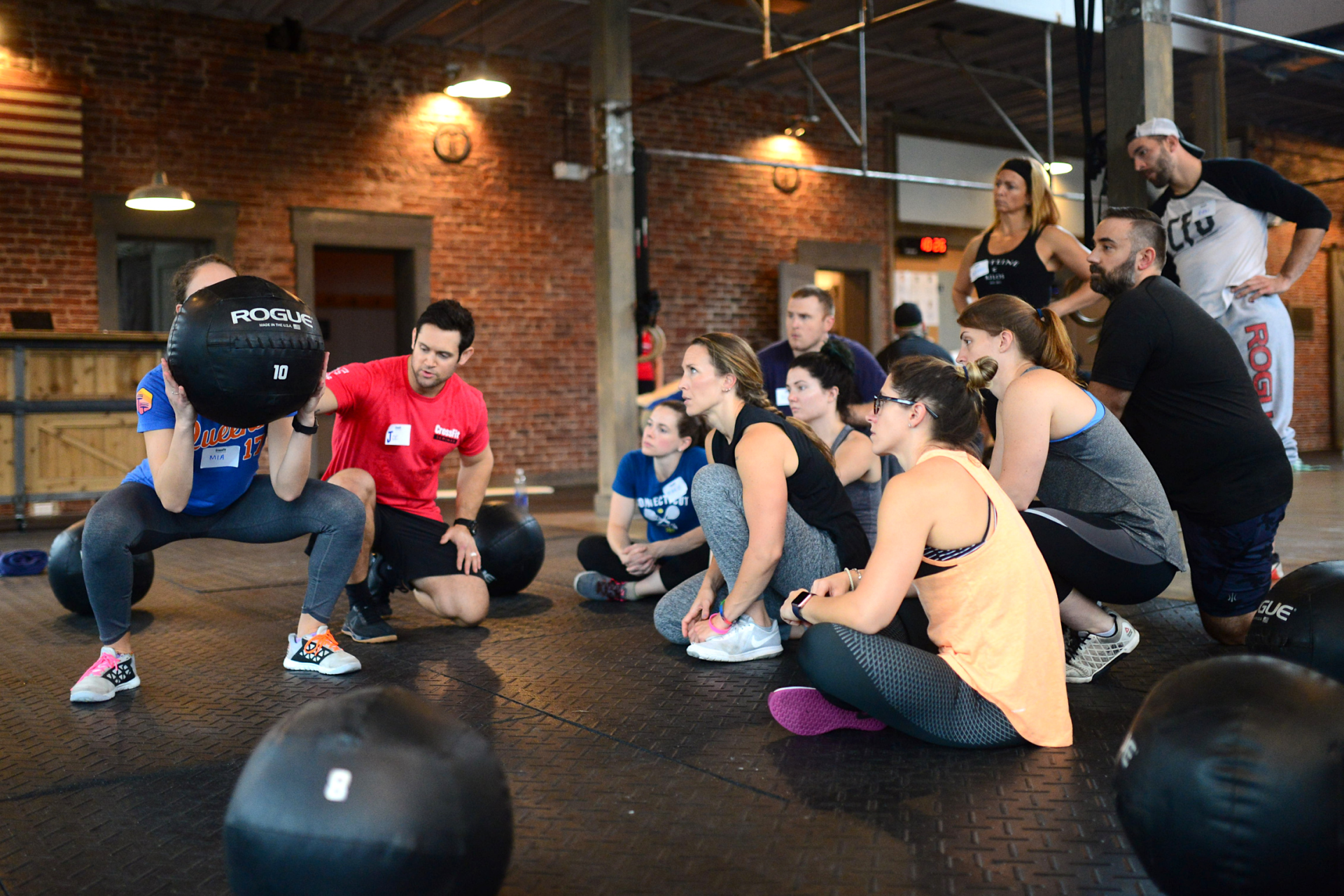 crossfit-trainer-explaining-an-exercise-to-a-class