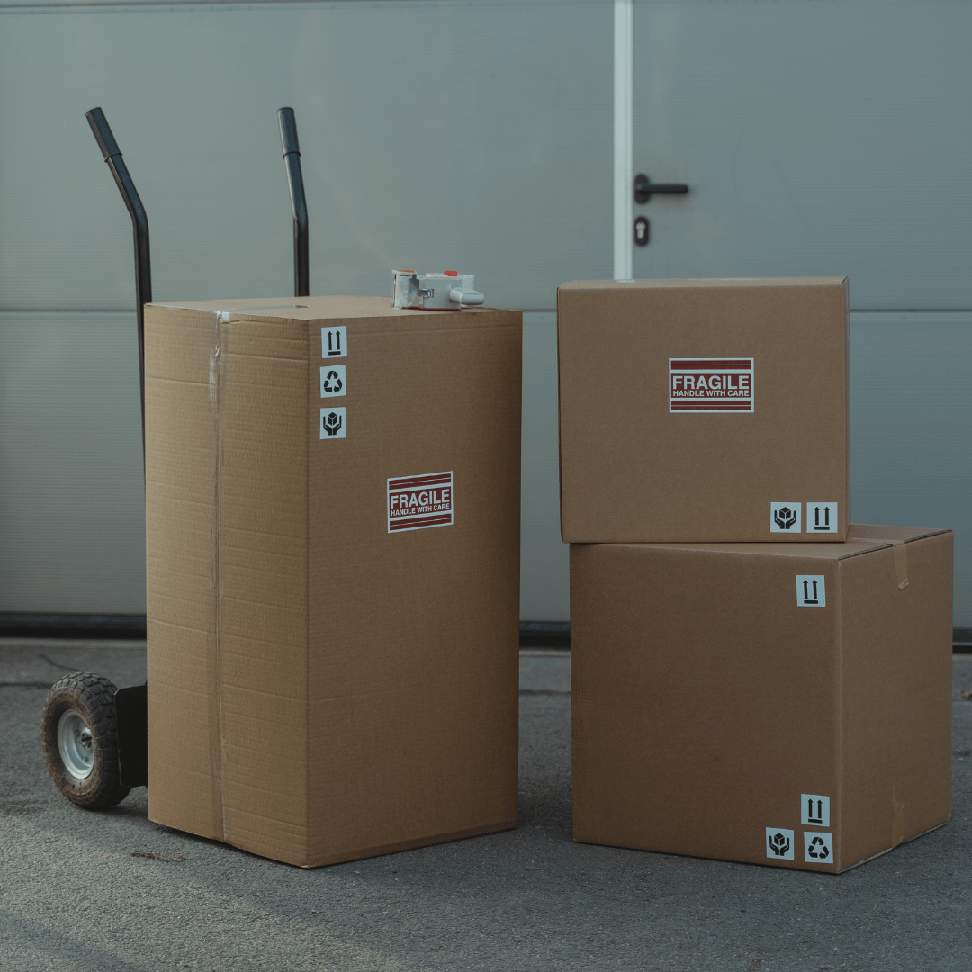 Three cardboard boxes stacked on top of each other with fragile stickers on them