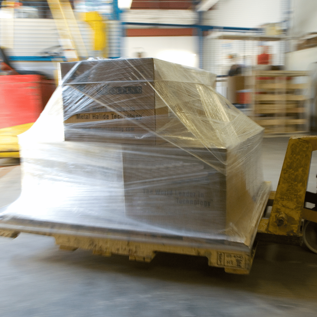 A stack of boxes wrapped in plastic sits on a pallet