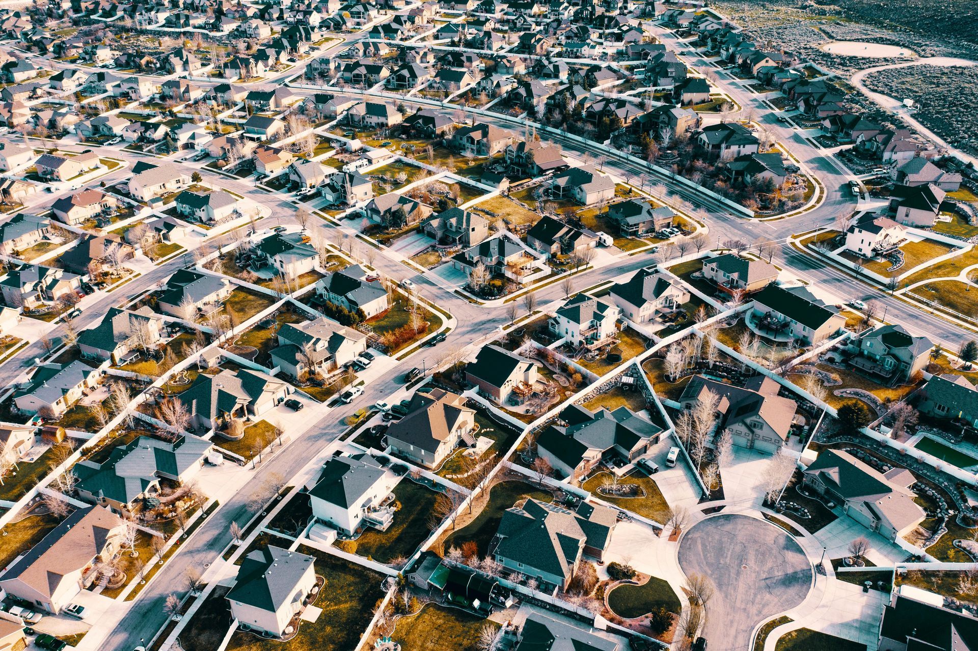 Aerial view of residential housing development – analyzing neighborhood market trends