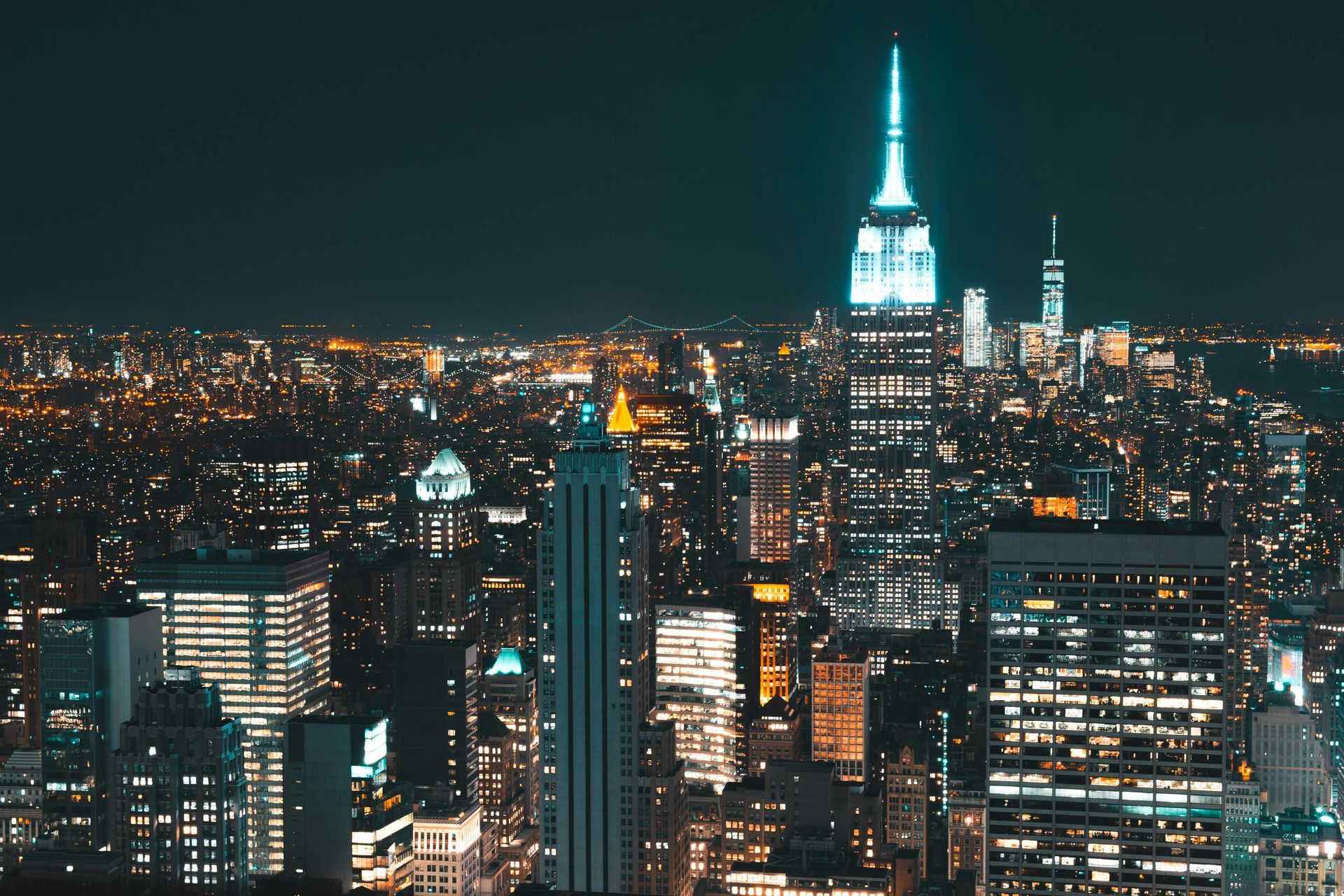 The empire state building is lit up at night in new york city