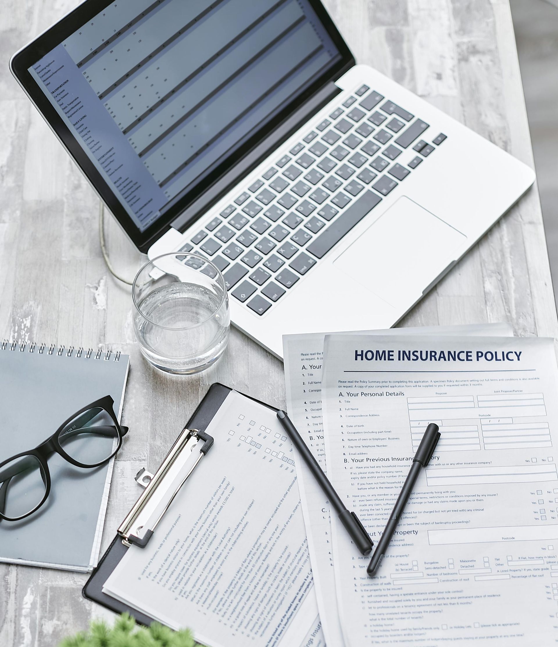 Documents and glasses on desk – understanding title insurance and living trust requirements