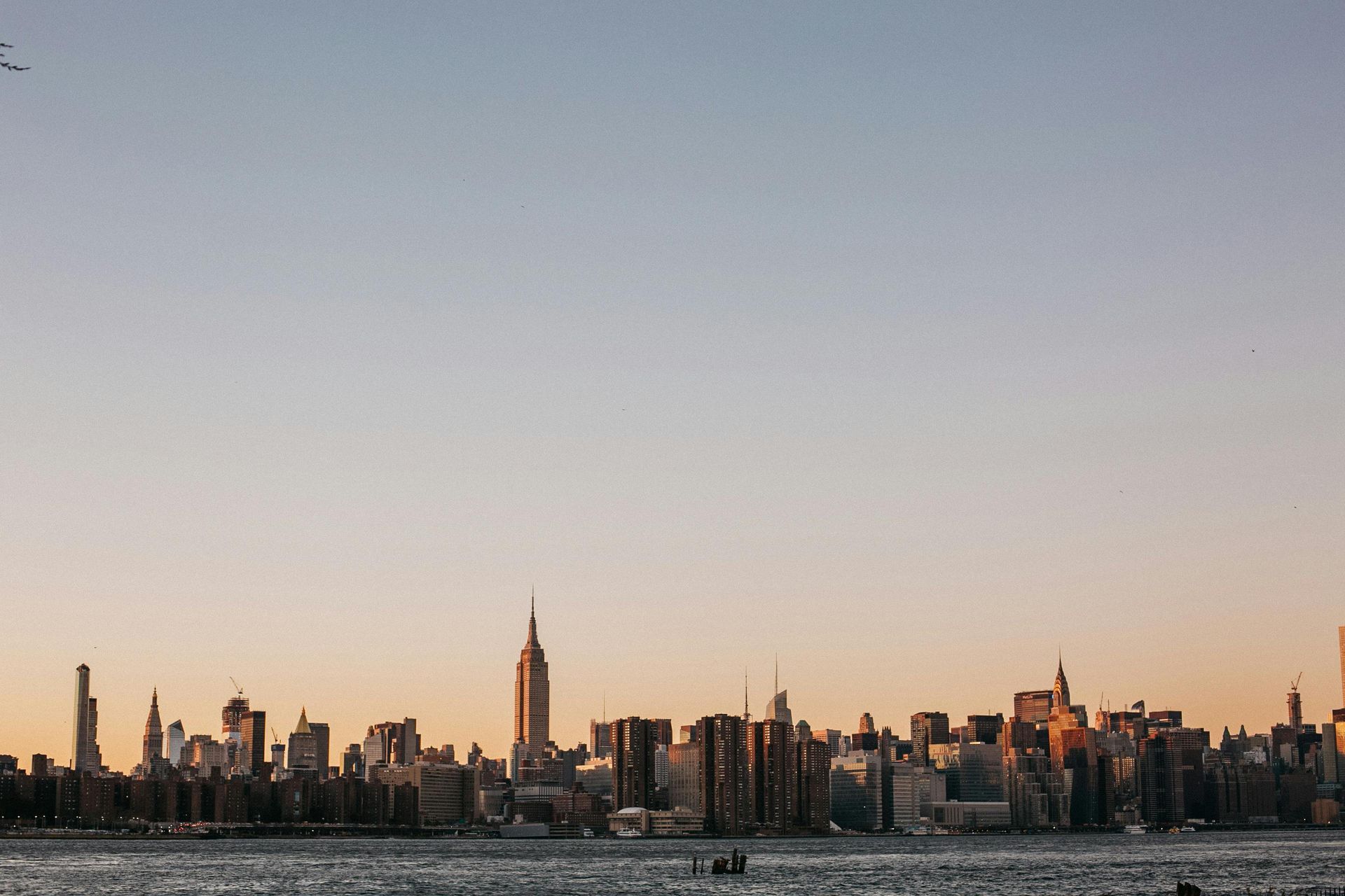 The empire state building is lit up at night in new york city