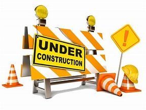 A construction barrier with a sign that says under construction