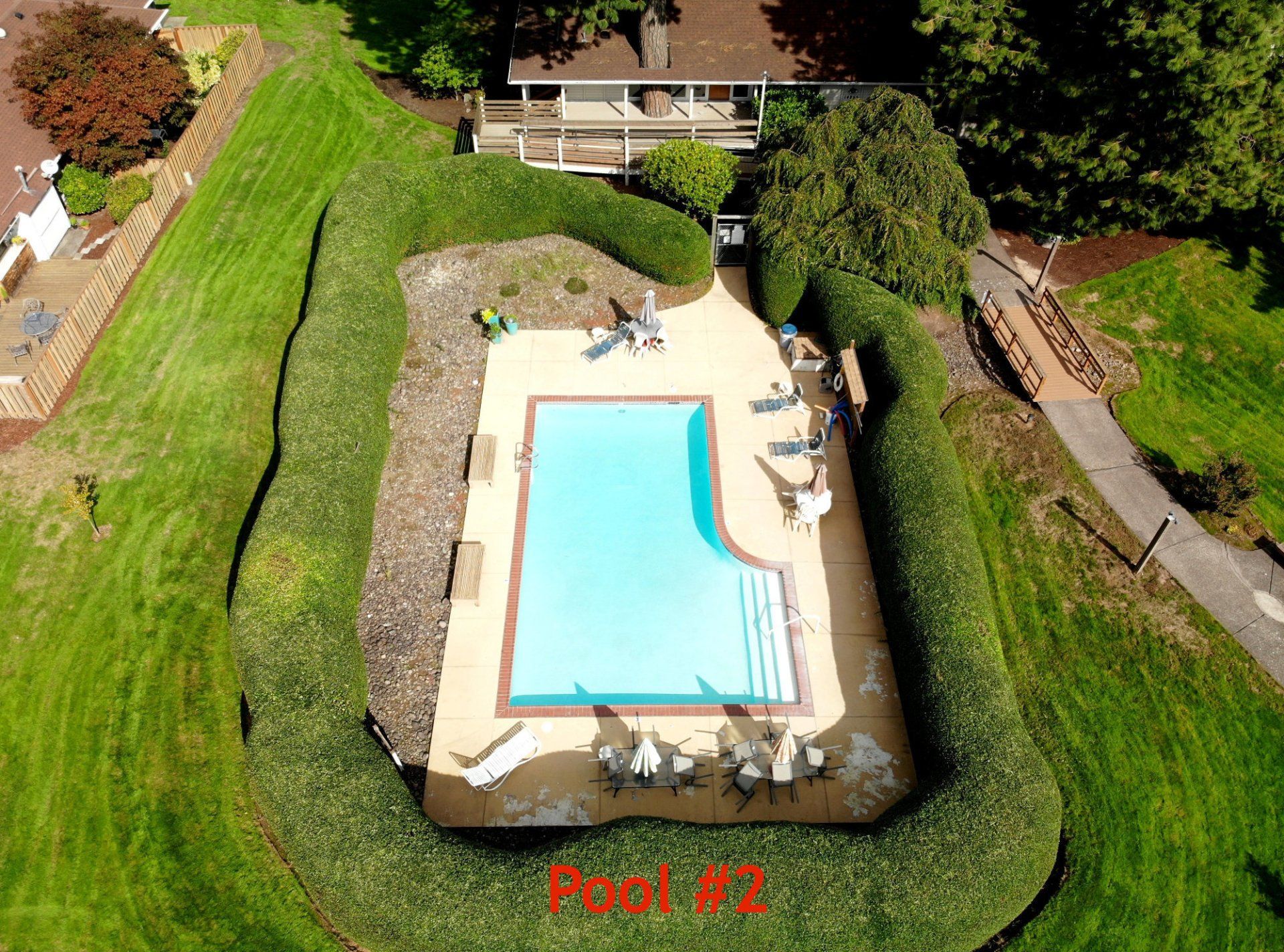 An aerial view of a large swimming pool with the words pool # 2 below it