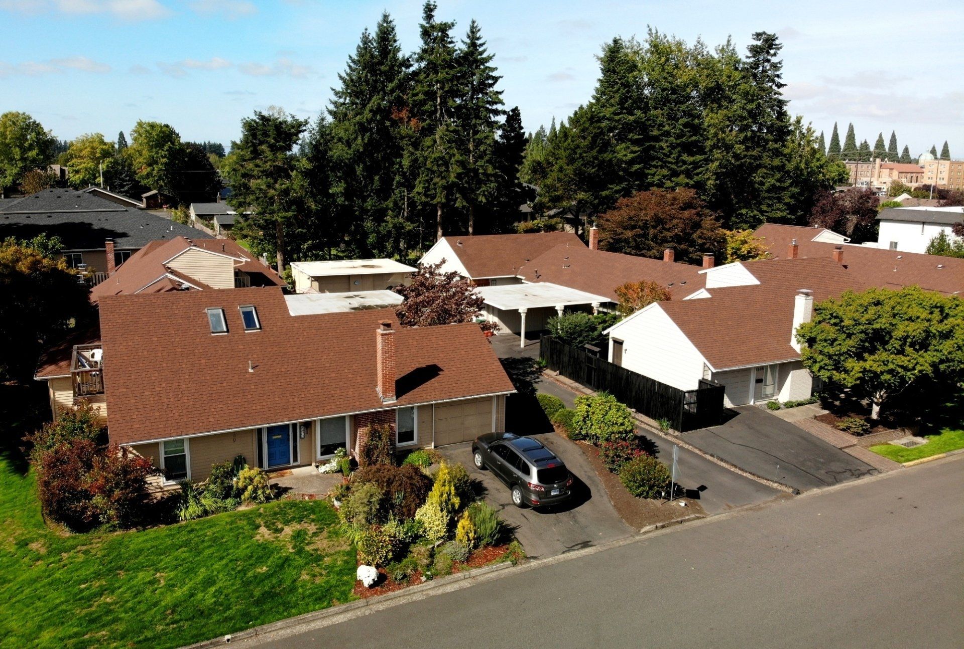 An aerial view of a residential area with houses and trees