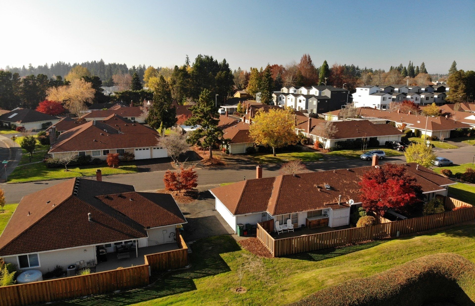 An aerial view of a residential area with houses and trees
