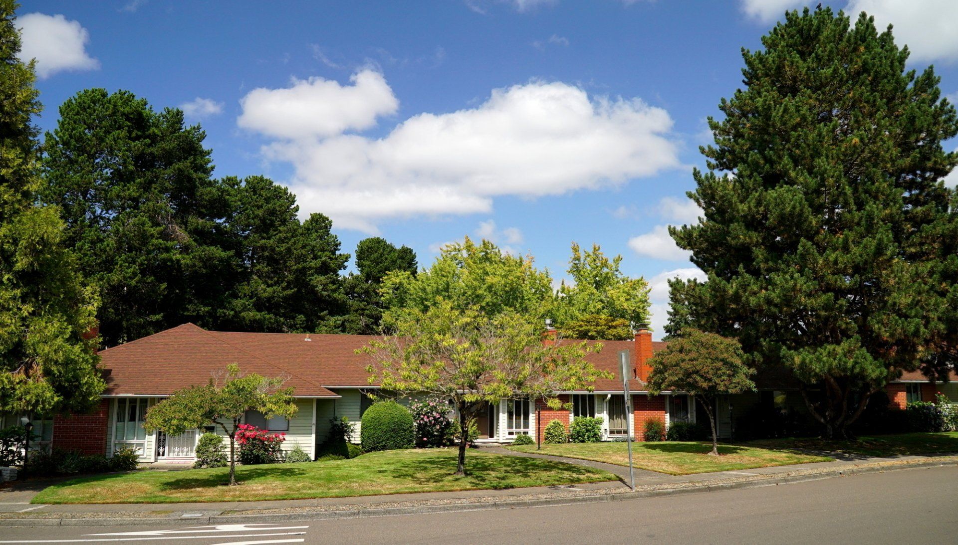 A house with a red car parked in front of it