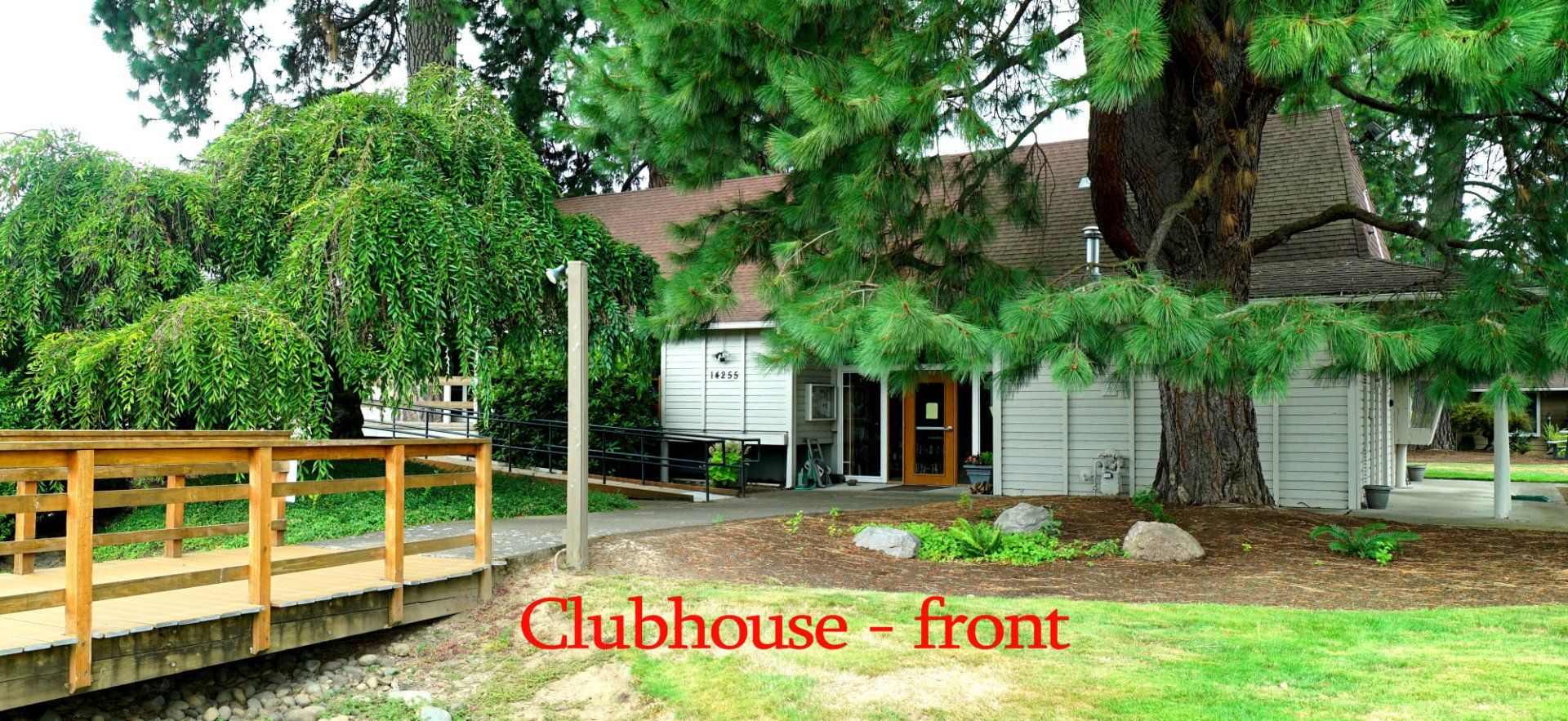 The front of a clubhouse with a bridge in front of it