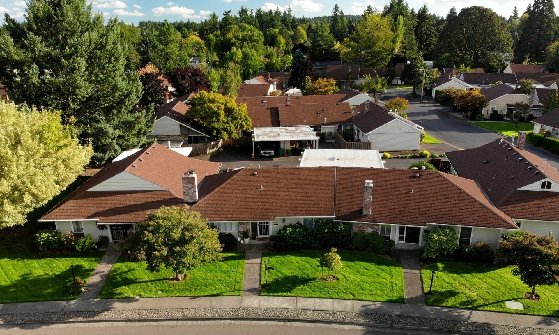An aerial view of a residential area with houses and trees