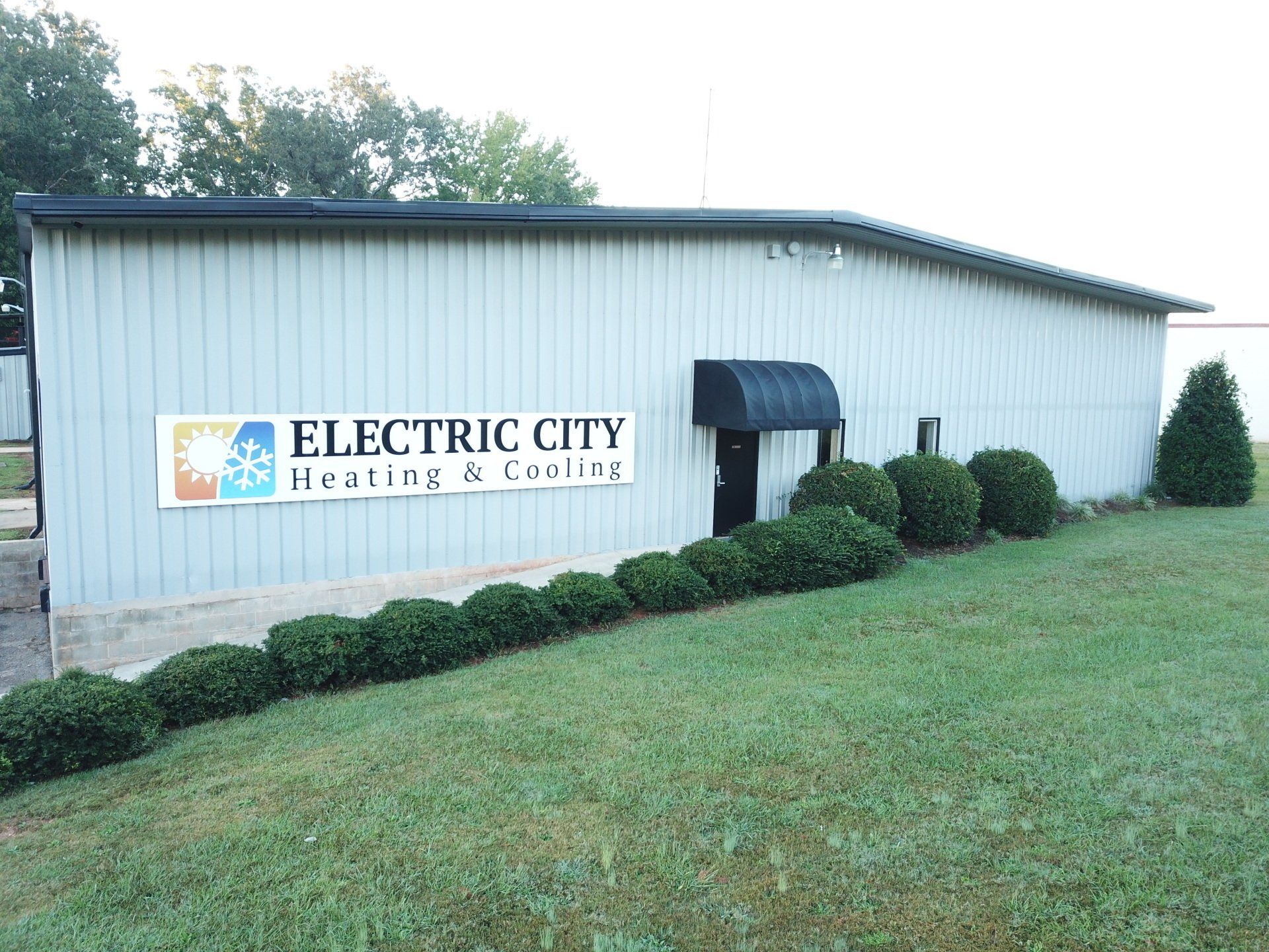 A building with a sign that says electric city heating and cooling