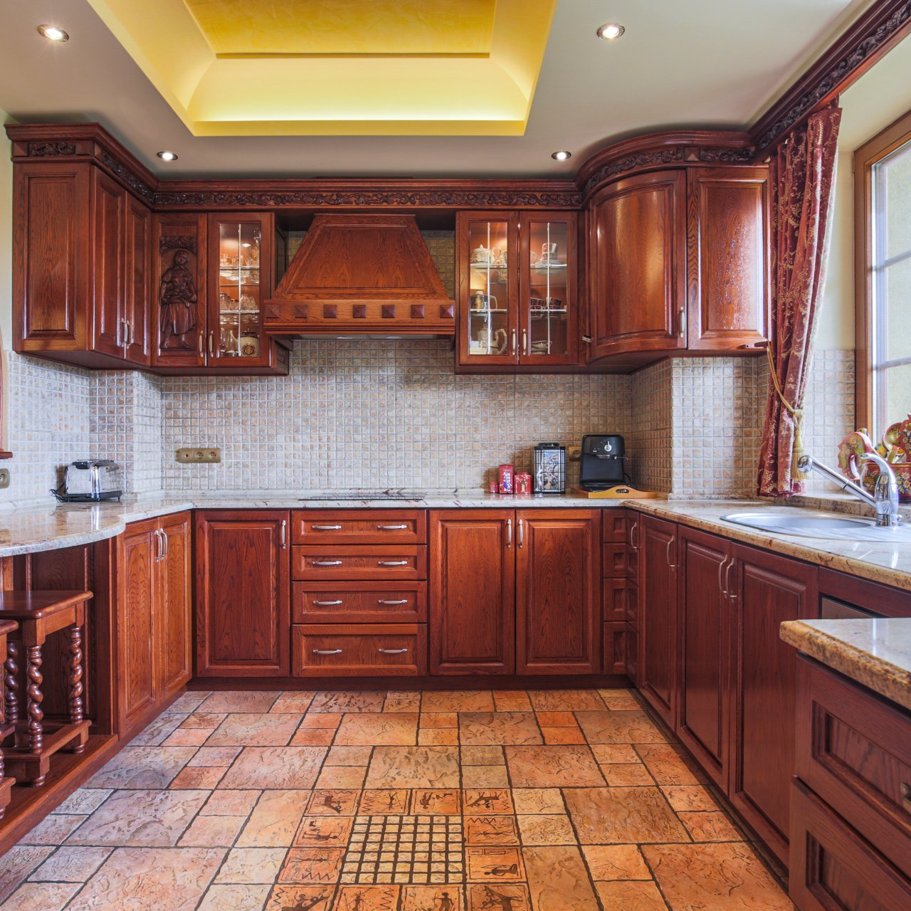 A kitchen with wooden cabinets and a tiled floor