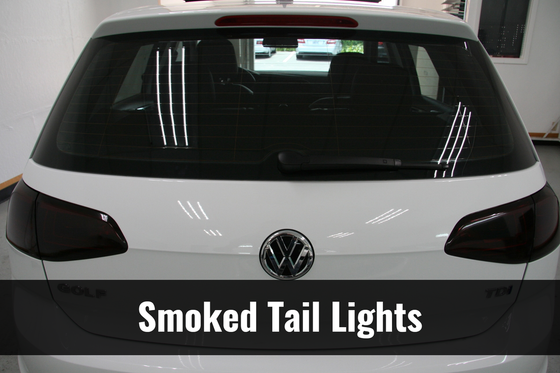 A white car with smoked tail lights on it