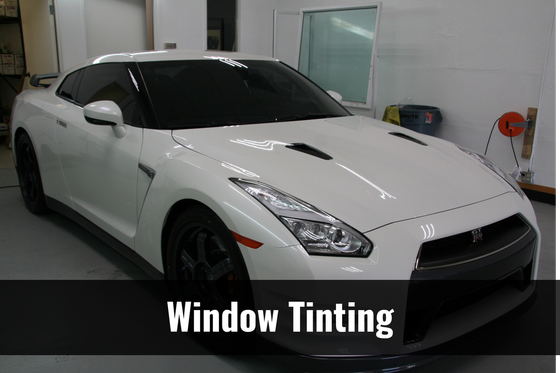 A white sports car with window tinting on it