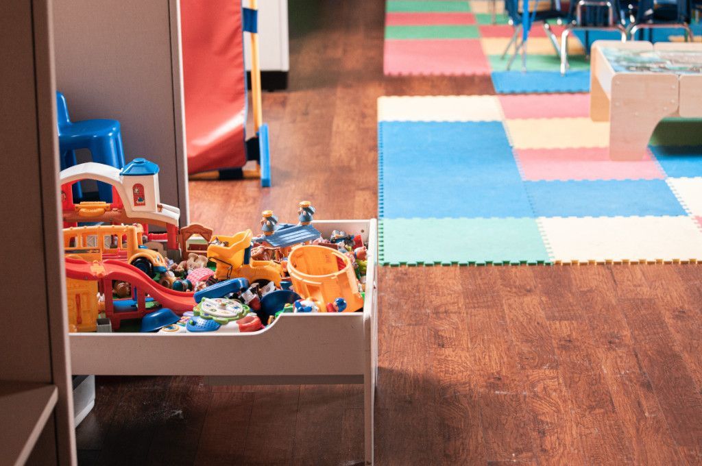 A kindergarten room showing toys and mat with clean timber flooring