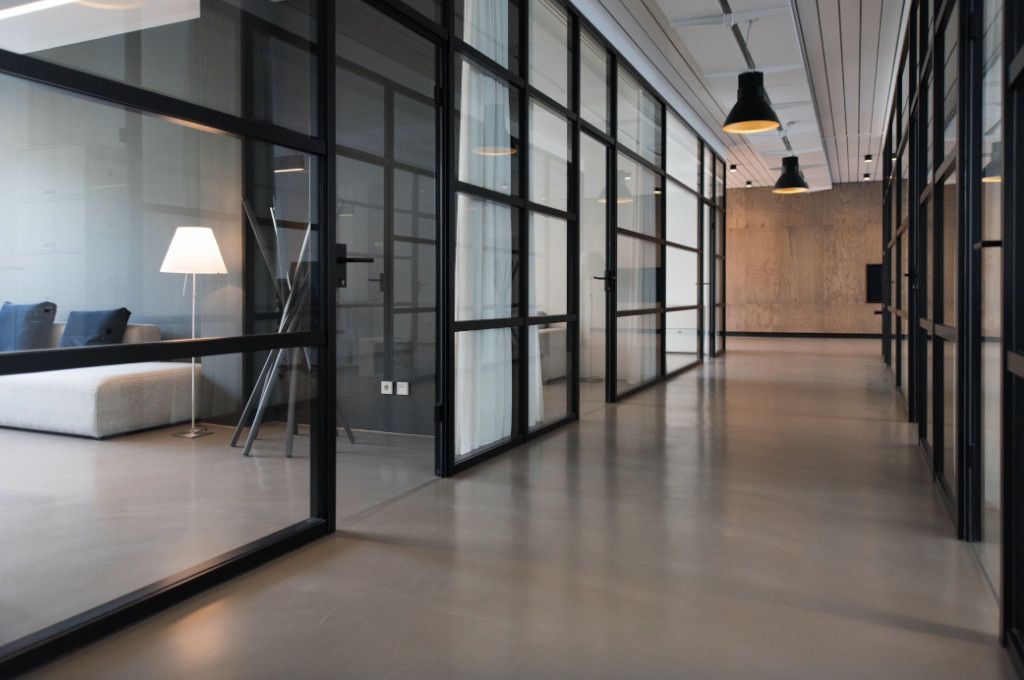 A modern office hallway with offices to the side