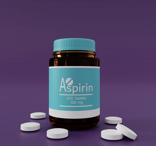 Bottle of aspirin tablets with scattered pills on a purple surface.