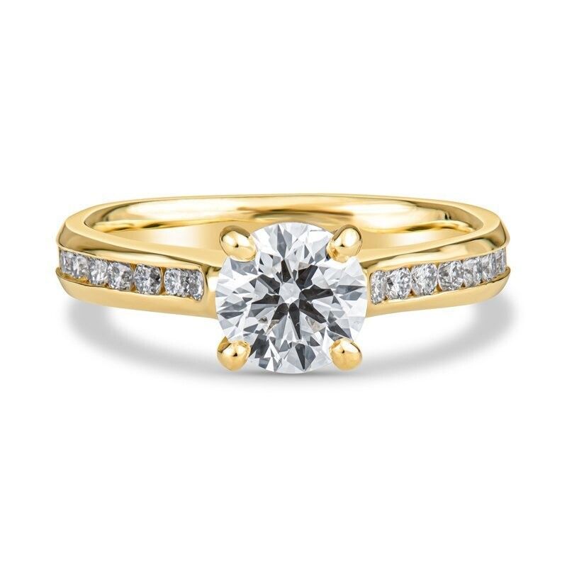 A yellow gold ring with a diamond in the center