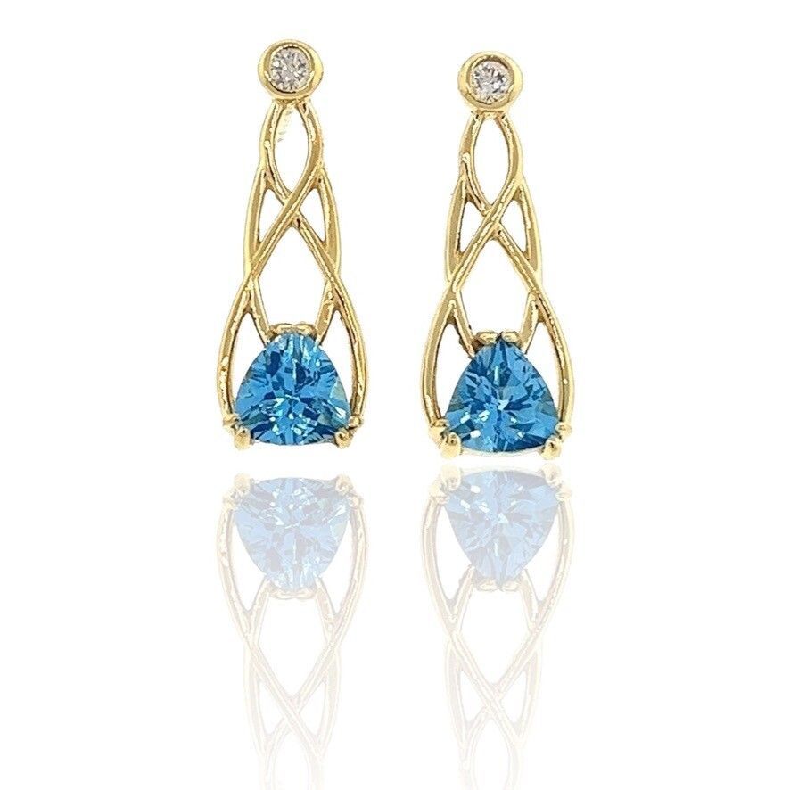 A pair of yellow gold earrings with blue topaz and diamonds