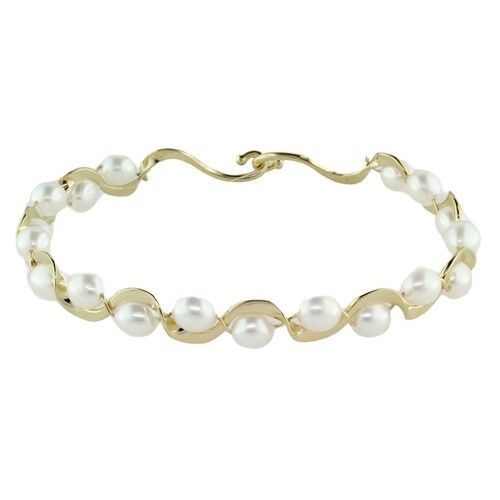 A gold bracelet with white pearls on a white background.