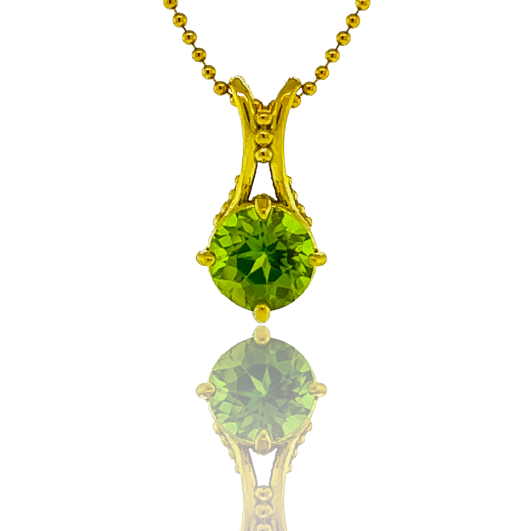 A necklace with a green stone on a gold chain