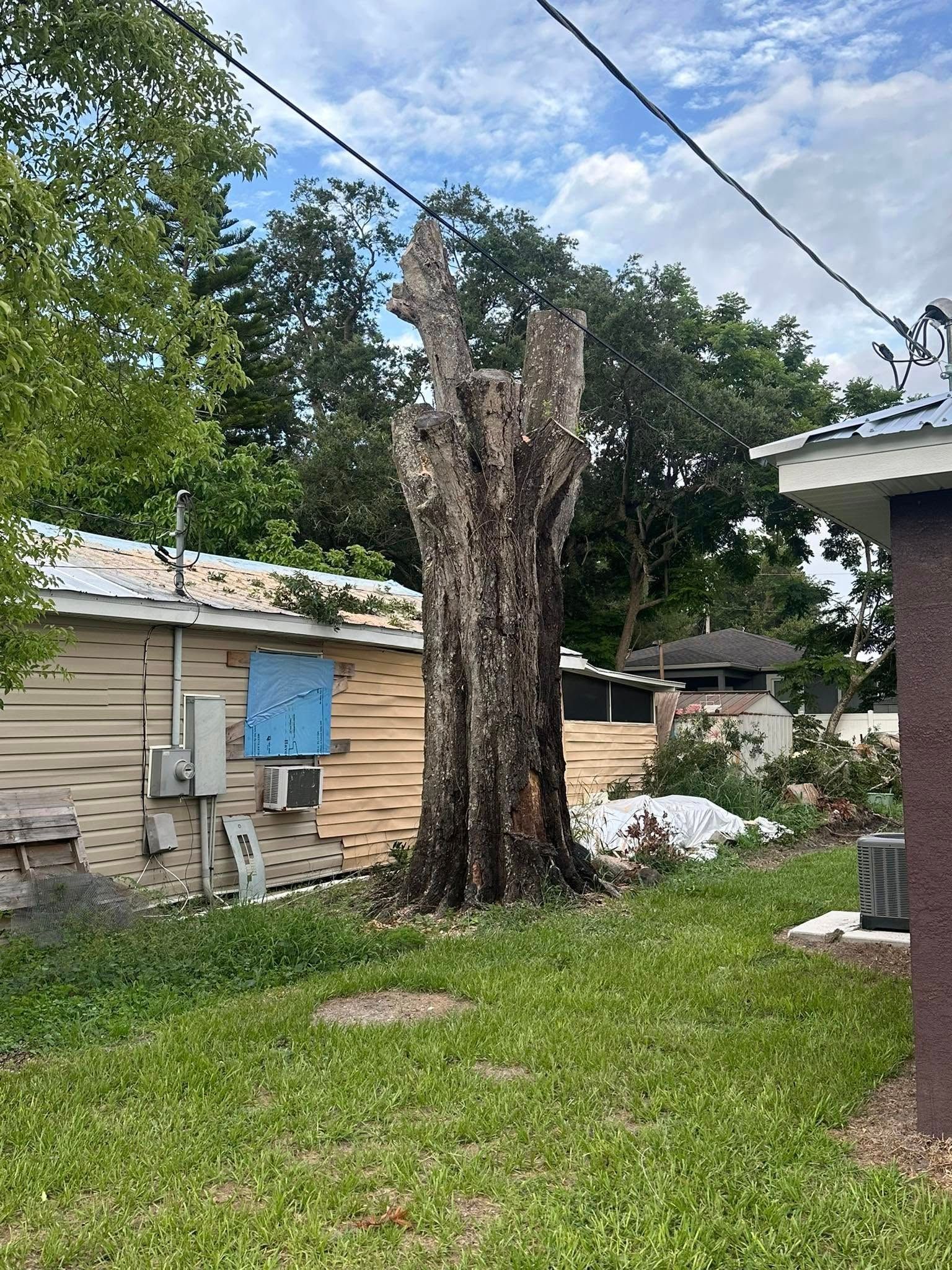 A man wearing a hard hat and goggles is standing in a room.