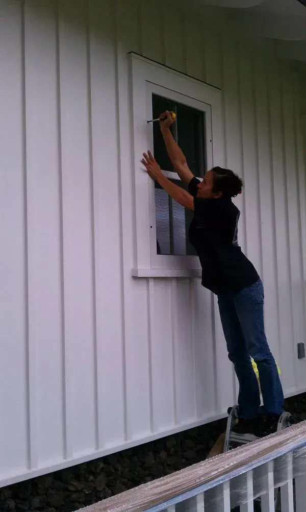 Worker installing a window screen — Makawao, HI — Hawaiian Door & Window Screens
