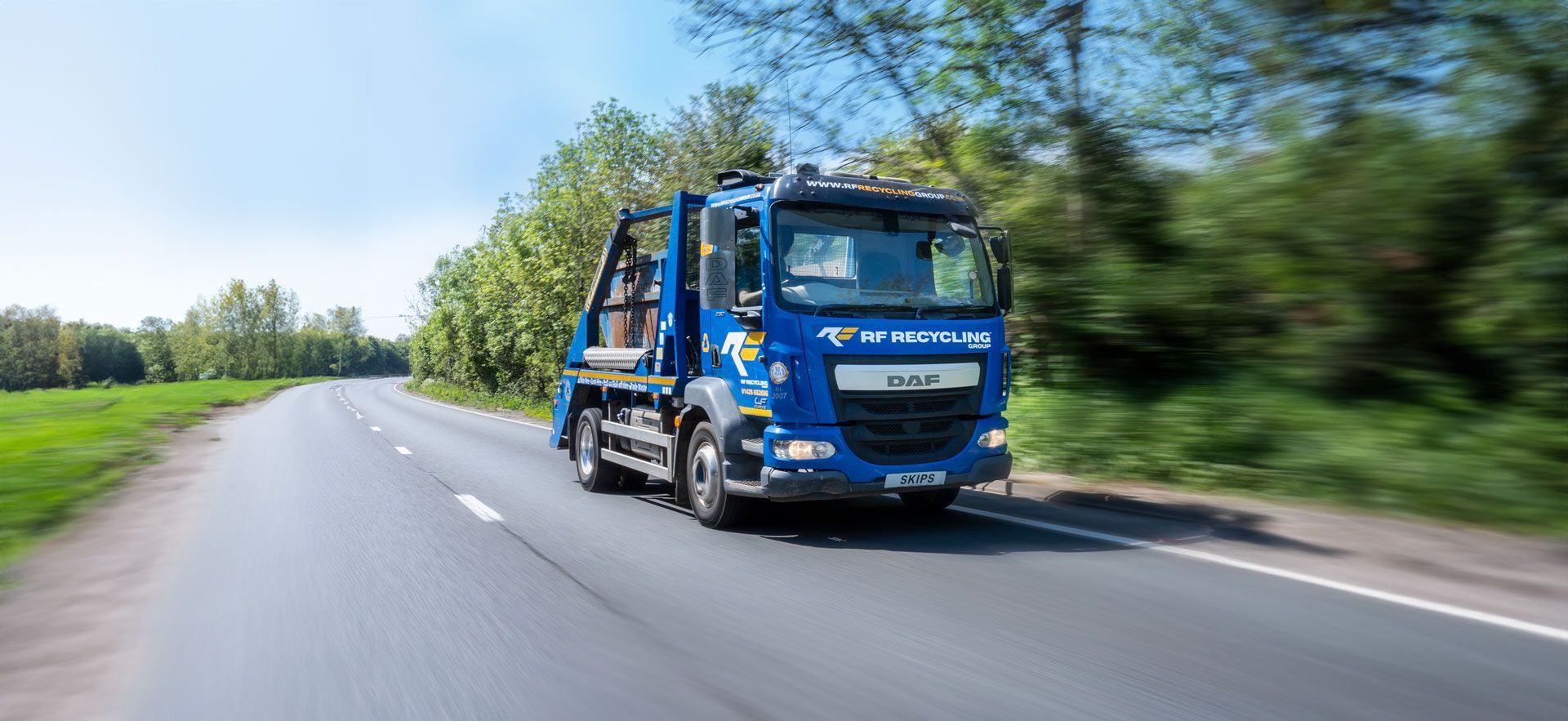 rf recycling group skip lorry on the highway
