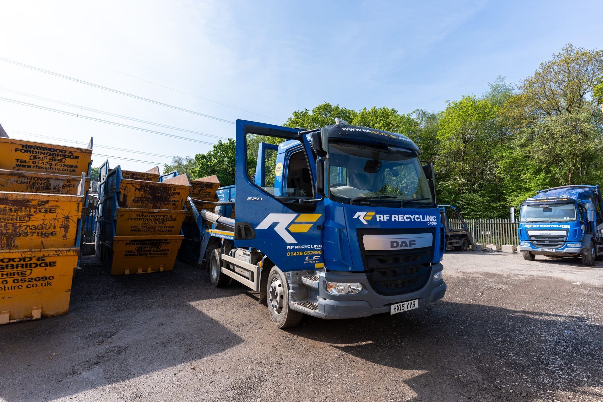 rf recycling lorry parked up next to empty skips