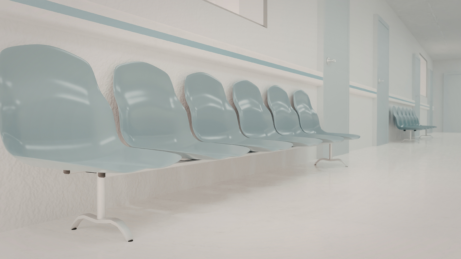 Empty medical waiting room with gray chairs, reception desk, and wall-mounted TV screens