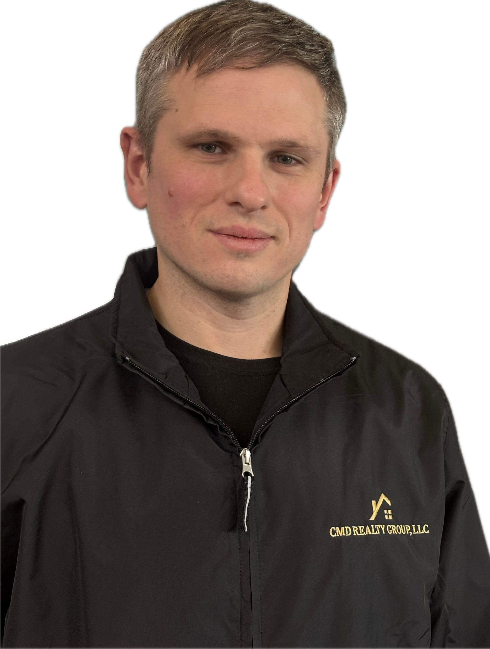 A man in a white shirt is smiling for the camera.