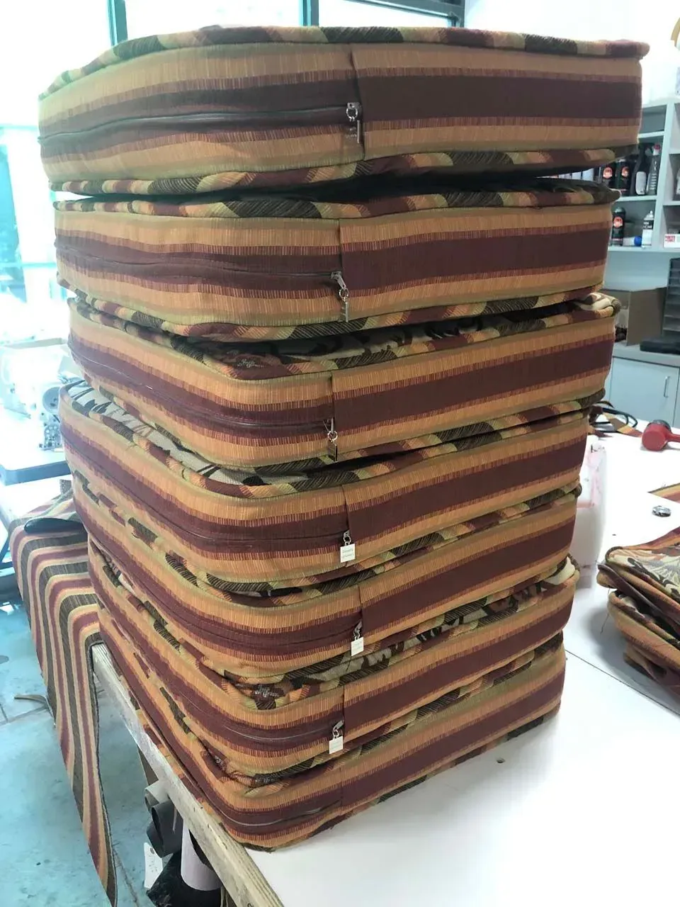 A stack of cushions are sitting on top of each other on a table.