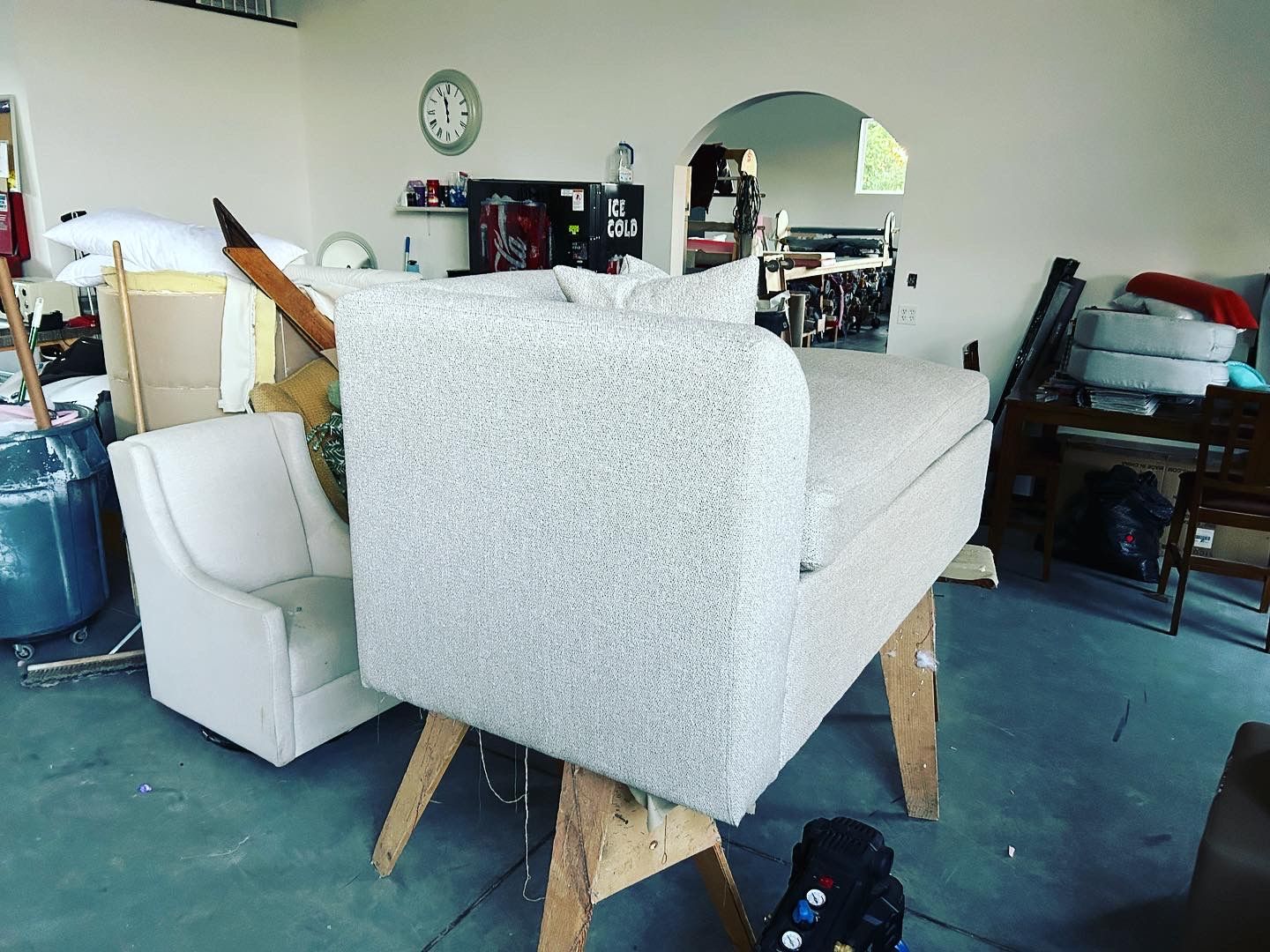 A couch is sitting on a wooden trestle in a room.