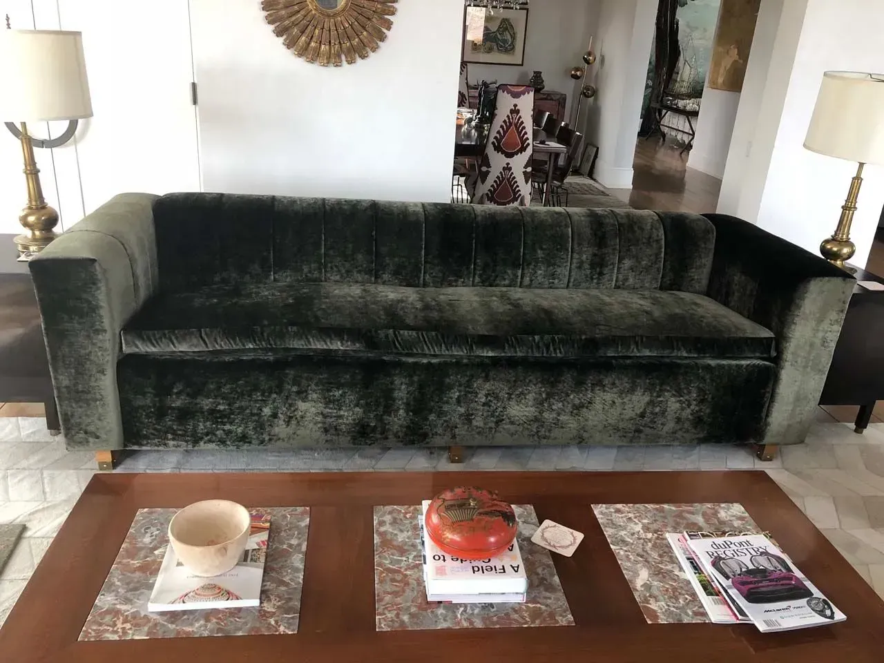 A living room with a green couch and a coffee table