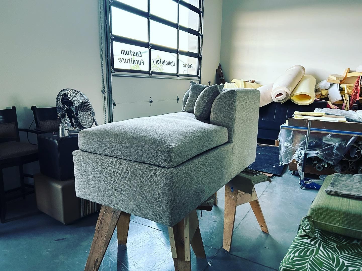 A chair is sitting on a wooden stool in a room.