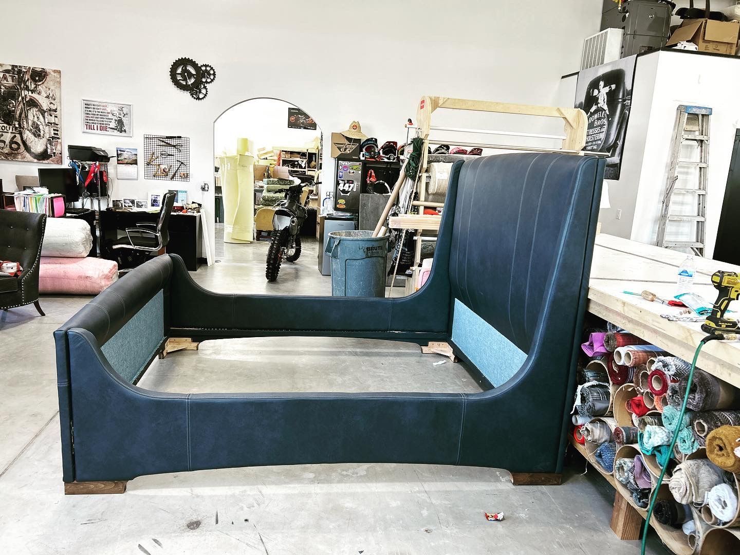 A bed frame is sitting on the floor in a room.