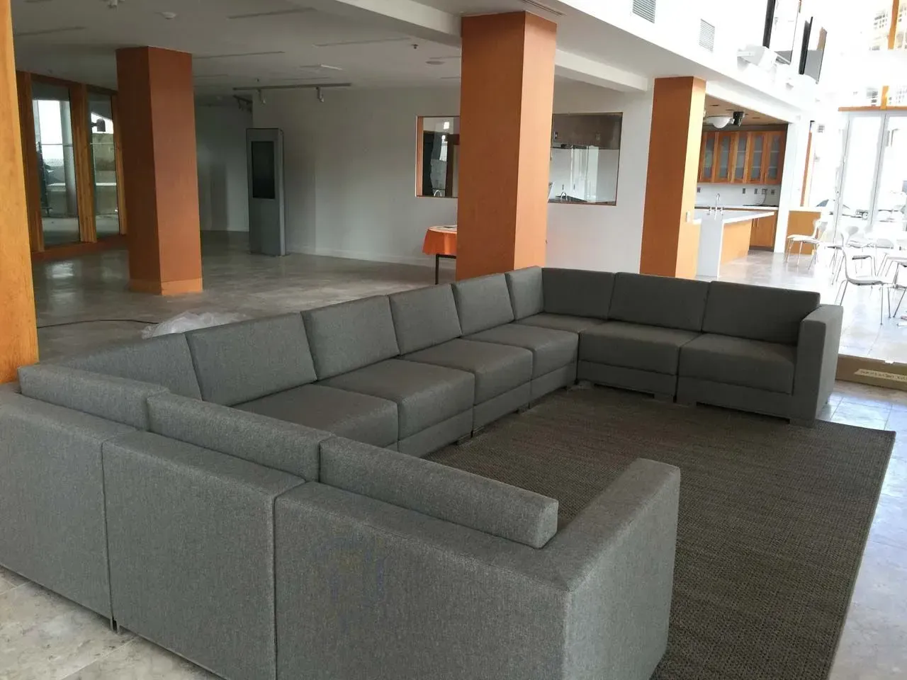 A large sectional couch in a large room